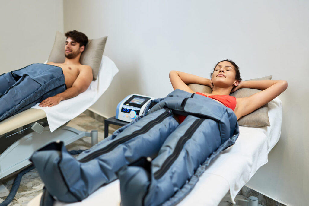 relaxed woman her boyfriend enjoying pressotherapy wellness center